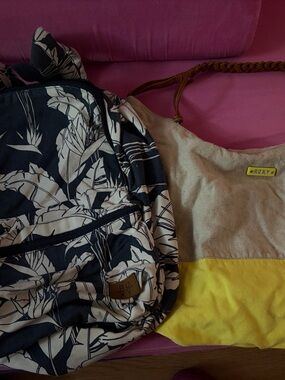 Roxy navy and white floral backpack with tan and yellow canvas shoulder bag